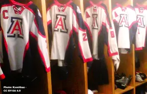 University of Arizona hockey team uniforms handing in the locker room.