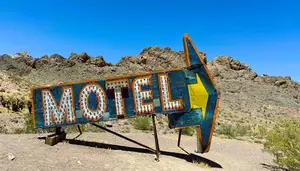 motel sign pointing the way down the road