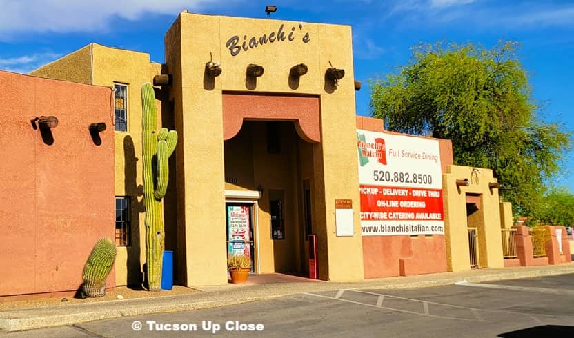 front entry of a restaurant with sign showing all details