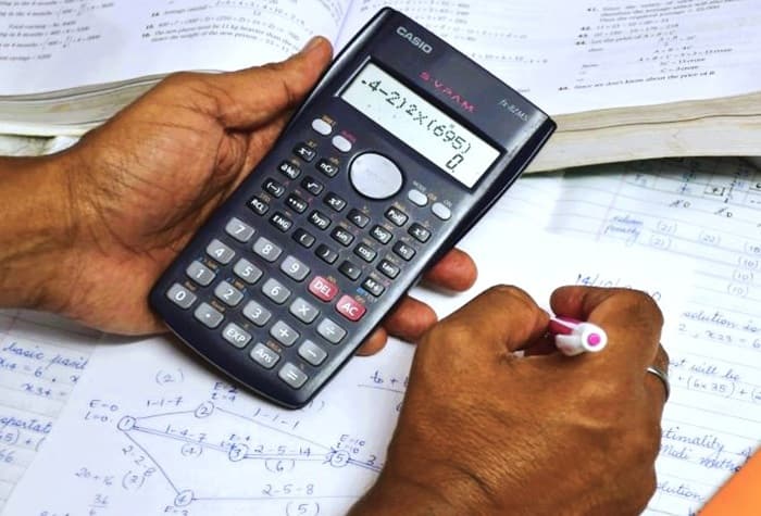 hands at work on a calculator