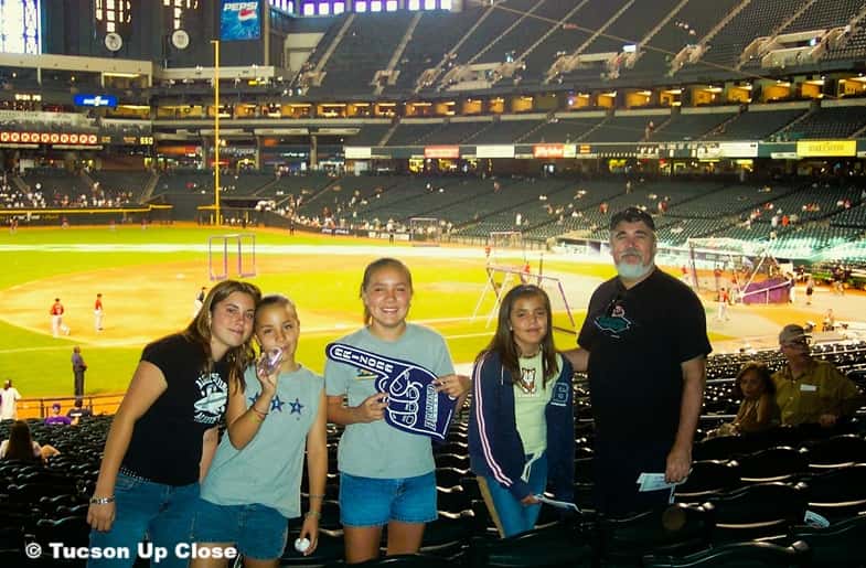 A man and his granddaughters at an Arizona Diamondbacks baseball game