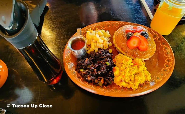 breakfast plate with pancakes and accompaniments