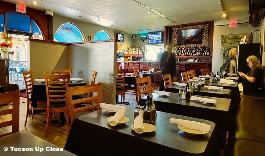 inside a resaurant with a bar and lots of seating