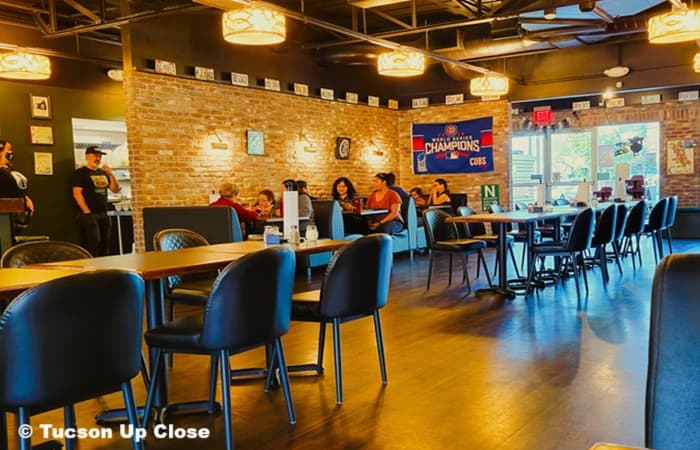 entry with people sitting at booths in a restaurant