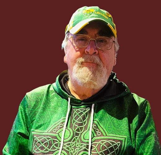 close up portrait of a man wearing glasses, who has a beard and mustache
