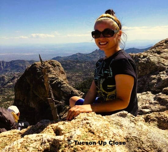 woman sitting at Windy Point Overlook onto Tucson below
