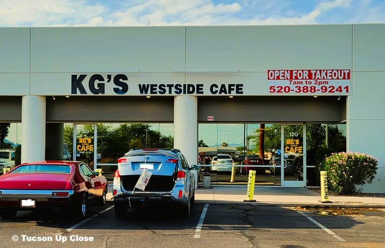 Storefront of a breakfast and lunch cafe with cars parked out front Storefront of a breakfast and lunch cafe with cars parked out front