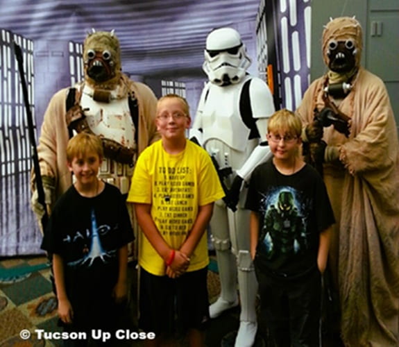 boys standing in front of Star Wars Live Figures boys standing in front of Star Wars Live Figures