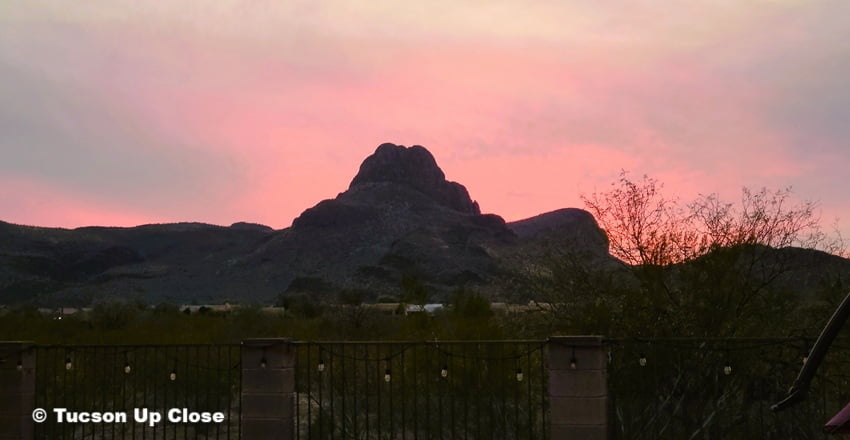 Glowing sky while the sun sets behind a distinctive mountain peak Glowing sky while the sun sets behind a distinctive mountain peak