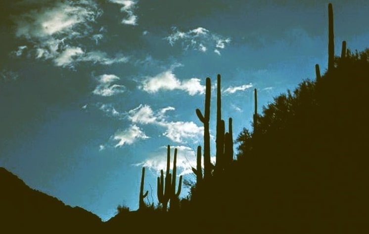 getting dark as the sun lowers and desert mountains are in the shadows
