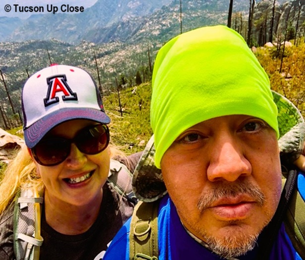 Selfie by man with a woman in a baseball cap in the mountains