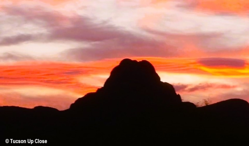 vivid sky behind a mountain at sunset