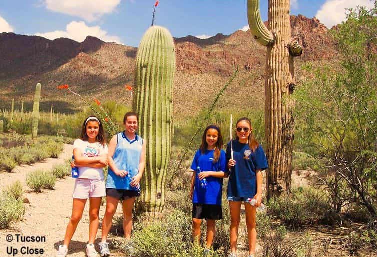 four girls on a desert path