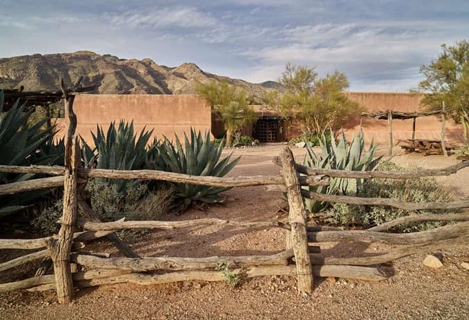 view of pueblo styled building with mountains in the background