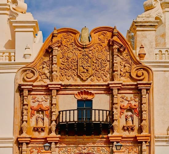 ornate facade in from of a historic Spanish mission in Tucson Arizona