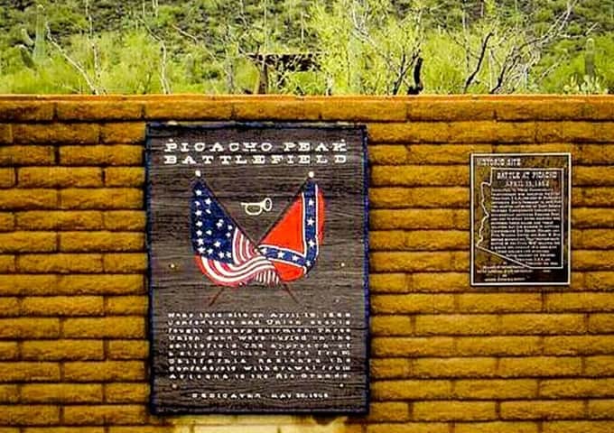historical marker plaque on an adobe wall in the desert at Picacho Peak State Park